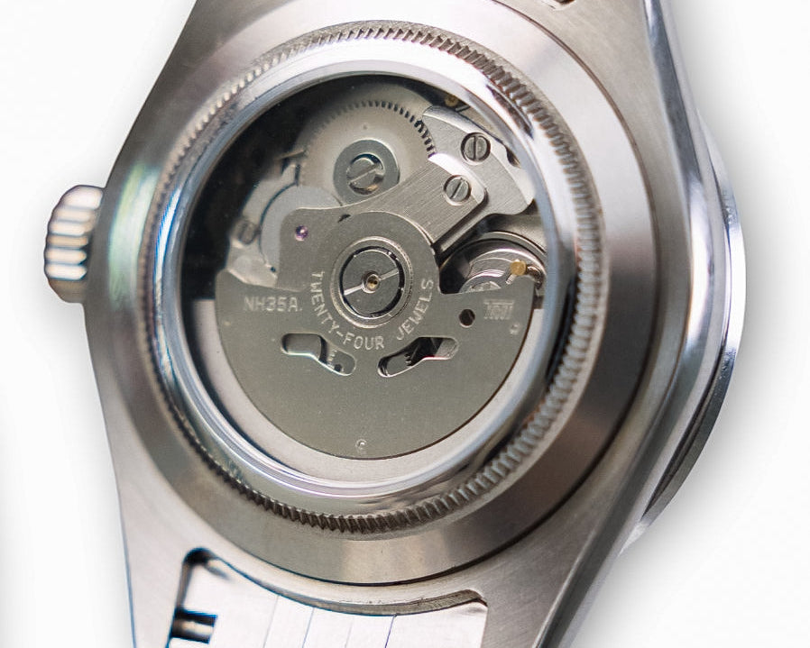 Close-up of a watch automatic mechanism on a white background